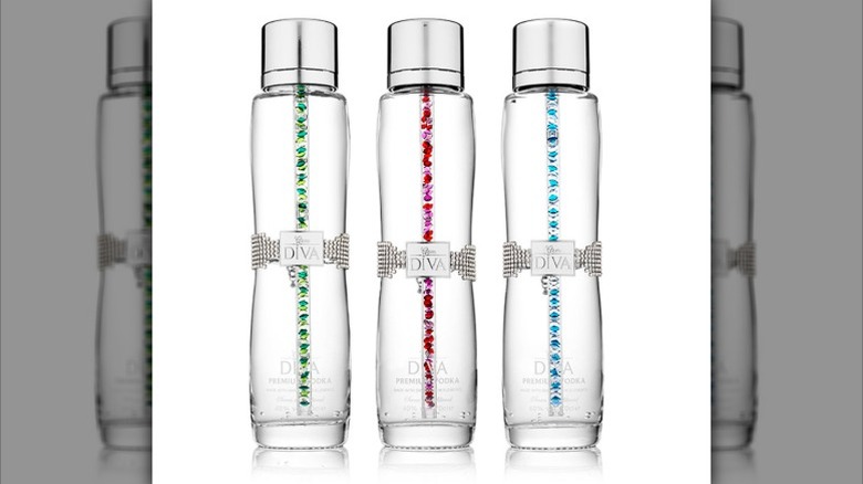 Three bottles of Diva Vodka with different colored crystal wands inside each, including green, pink, and blue