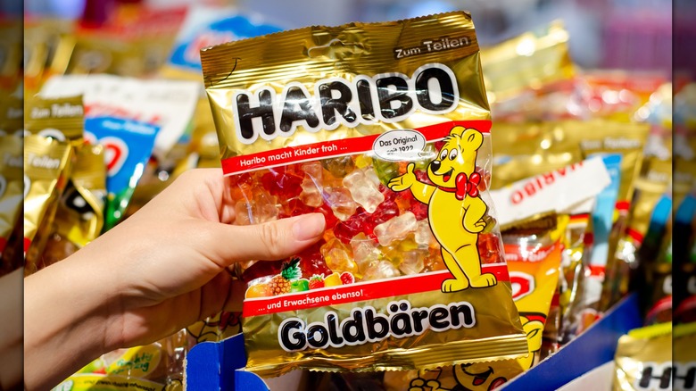 A hand holding a bag of Haribo Goldbears