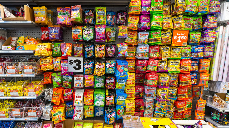 A store shelf at a Five Below featuring a wide array of candies, including Haribo and Life Savers