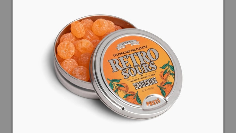 A Retro Sours tangerine tin with the top open on a white background