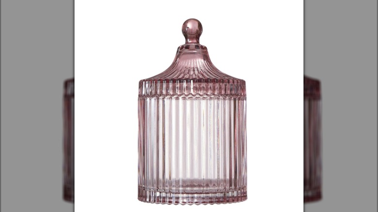 A translucent pink glass jar with a white background