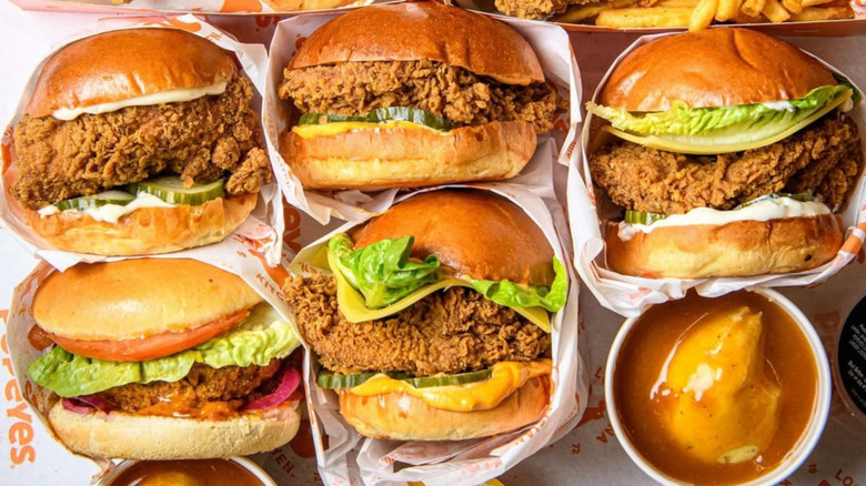 Five Popeye's chicken sandwiches and a side of mashed potatoes