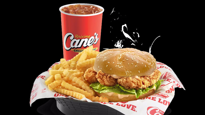 Cane's sandwich meal with a drink on a black background