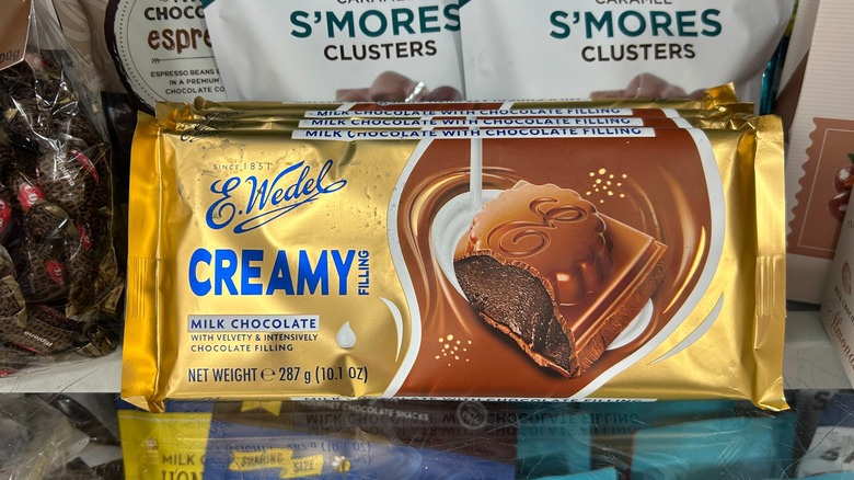 E. Wedel milk chocolate bar with chocolate filling in gold wrapper on shelf