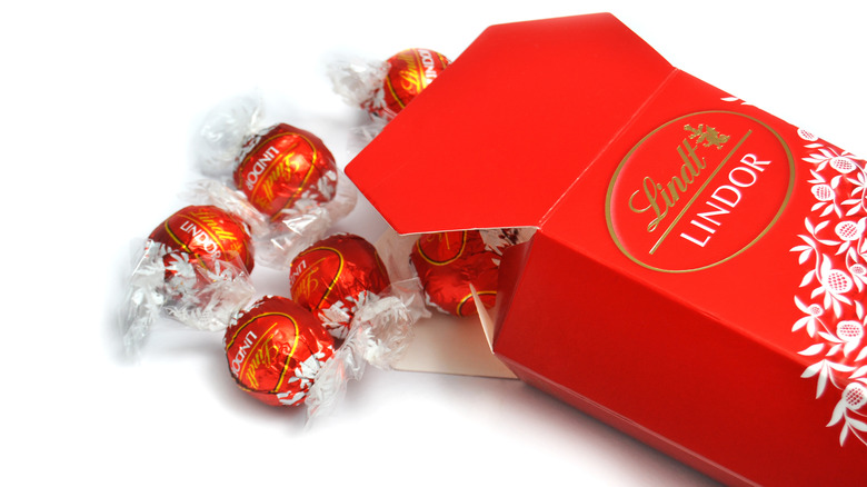 Red Lindt lindor box with truffles spilling out