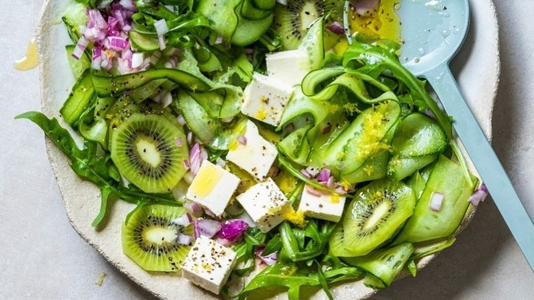 Salad with kiwis, cheese, and cucumbers