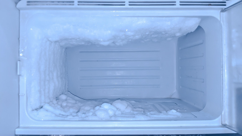 A freezer compartment with heavy frost buildup