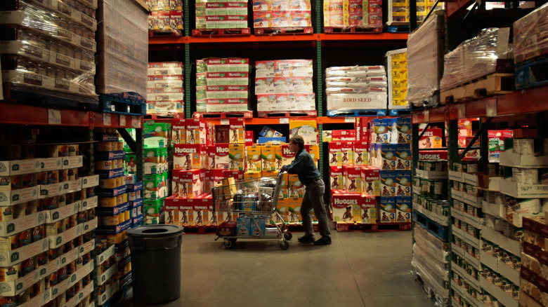 A shopper pushing a cart in Costco