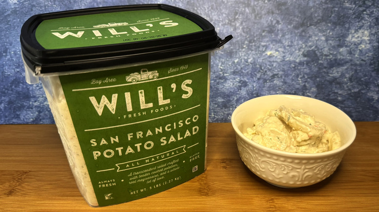 A container and bowl of potato salad