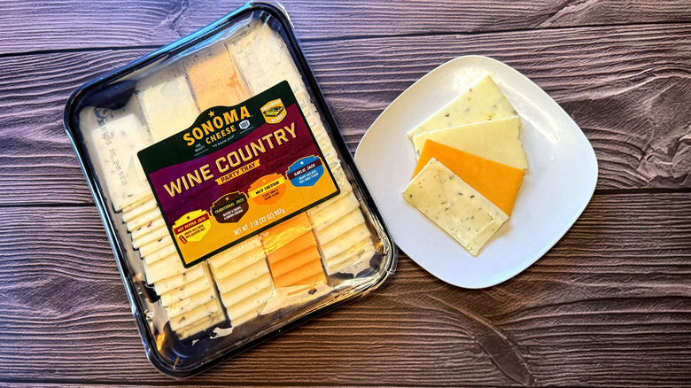 A variety pack of sliced cheeses next to slices on a plate