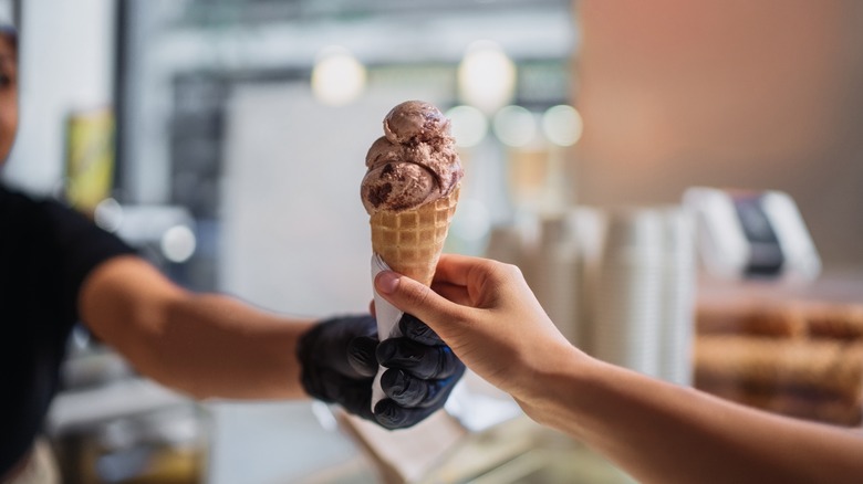 Ice cream cone handed to customer