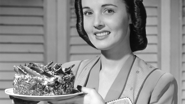 circa 1950s woman holding dessert