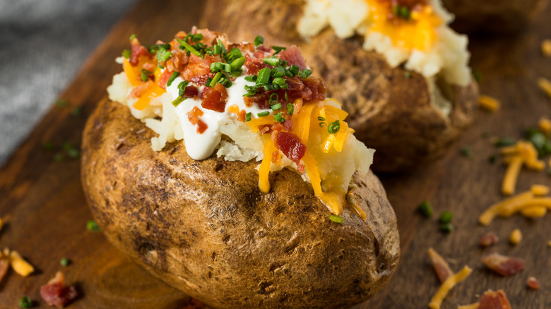Loaded baked potato with sour cream, cheese, bacon, and chives