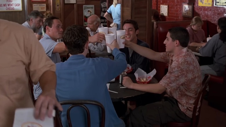 The four main characters of the film "American Pie" cheersing their drinks inside the Dog Years Diner