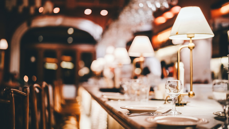 The interior of a restaurant with soft lighting at night
