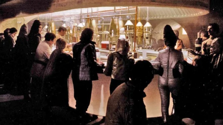 Patrons crowding around the bar of Mos Eisley Cantina from Star Wars