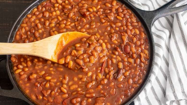 Baked beans, wood spoon, skillet
