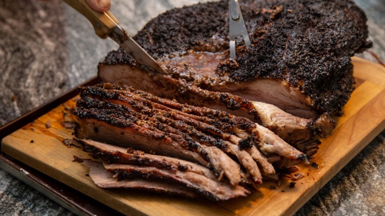 Smoked brisket on chopping board