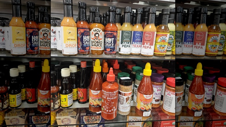 Assorted hot sauce bottles on two glass shelves