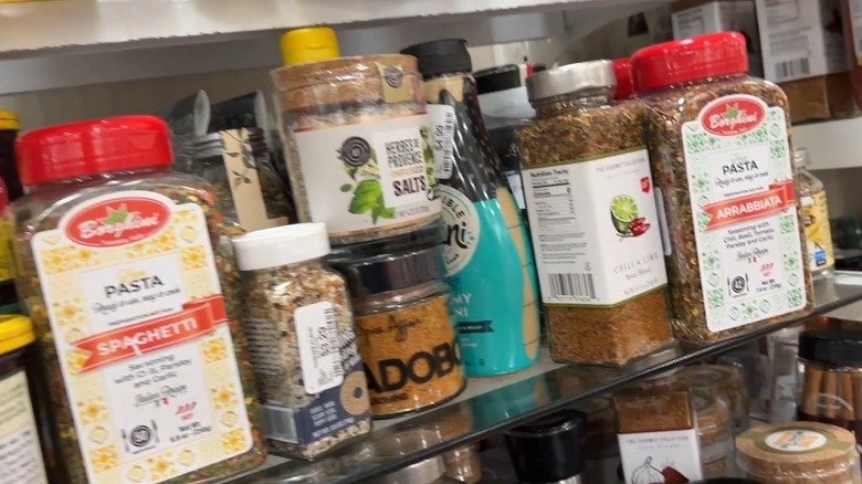 Large bottles of assorted seasonings and seasoning blends