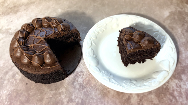 Chocolate cake, with one slice on a plate