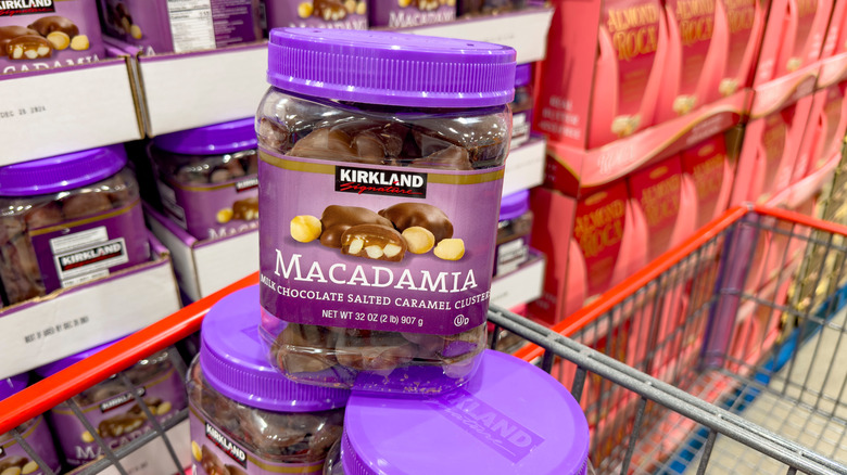a stack of Kirkland Signature macadamia nut clusters in a grocery cart