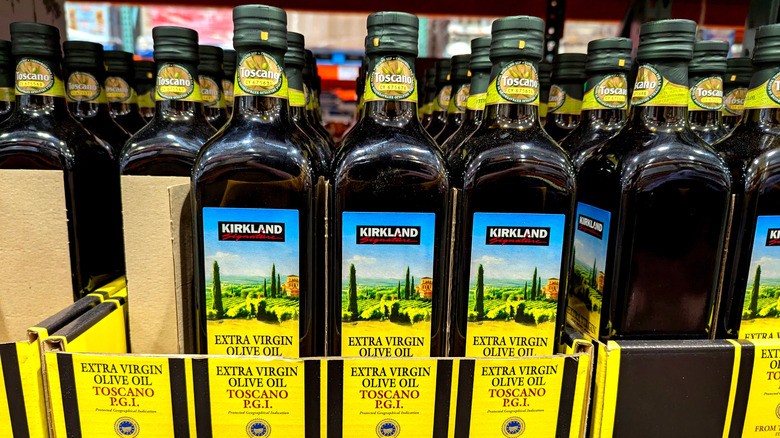 boxes of bottles of Kirkland Signature extra virgin olive oil on shelves