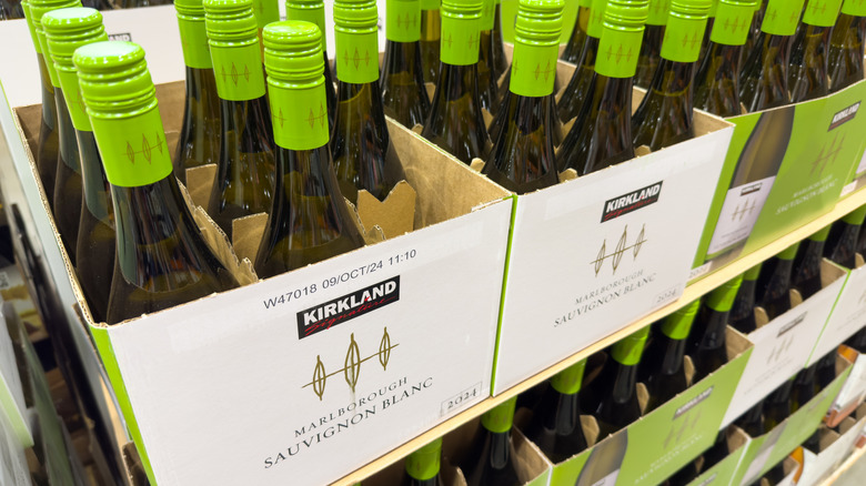 a row of bottles of Kirkland Signature Sauvignon Blanc on the shelves