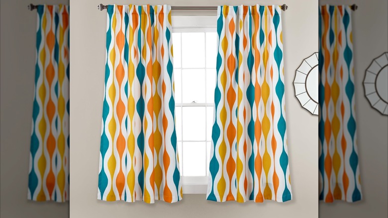 Long patterned drapes in teal, yellow, and orange colors
