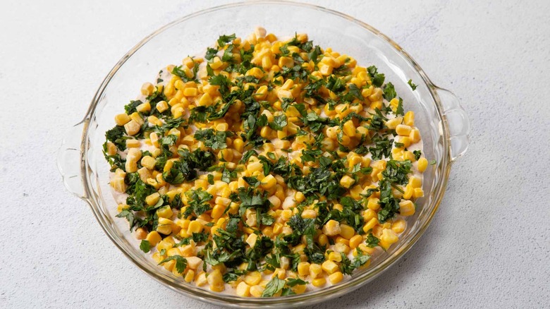 corn kernels and cilantro in a clear pie plate