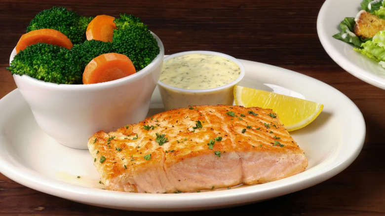 A Texas Roadhouse Grilled Salmon with mixed vegetables on a white plate
