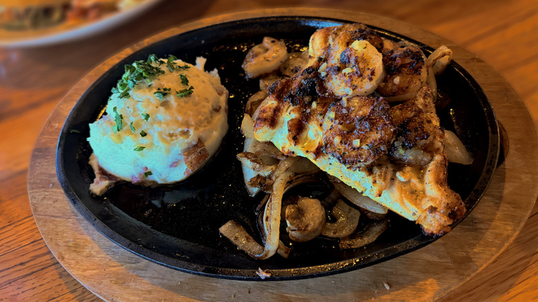 bourbon street chicken and shrimp dish on skillet with mashed potatoes at applebees