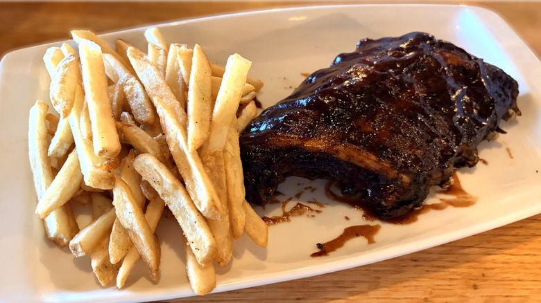 half rack of ribs on table with french fries at applebees