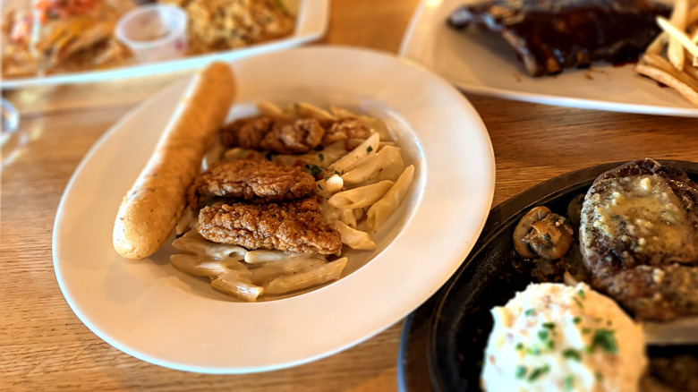 Close ups of various entrees at applebees on a table