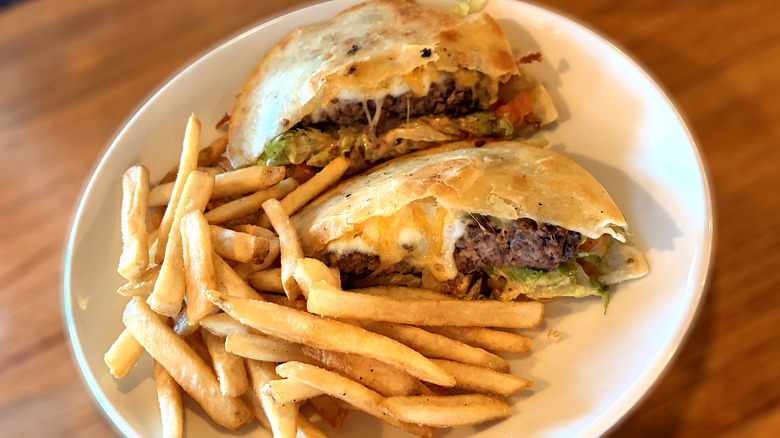 applebees quesadilla burger on plate with fries