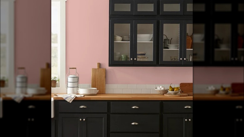 Kitchen with pink walls, dark cabinets