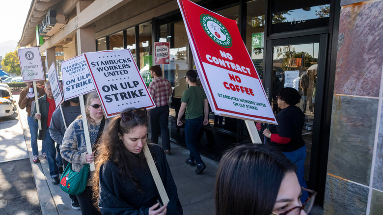 Starbucks employees protesting with strike signs