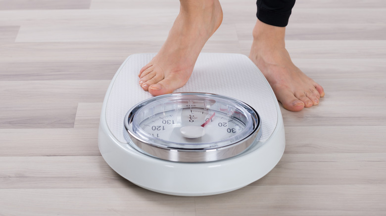 person stepping on scale