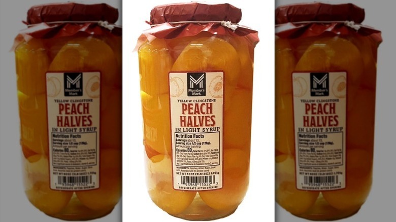 Peach halves in light syrup on white background