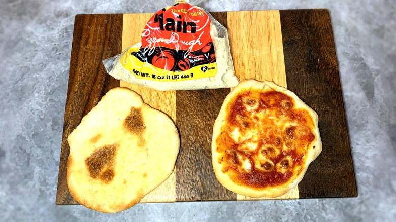 Bag of Trader Joe's pizza dough with cooked crust and pizza