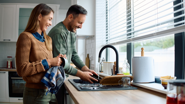 Couple handwashing dishes