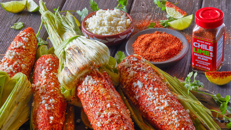Chile lime seasoning on corn next to a bottle of the seasoning, a bowl of the seasoning and a bowl of rice