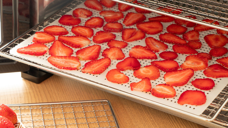 Strawberry slices laid out on oven rack