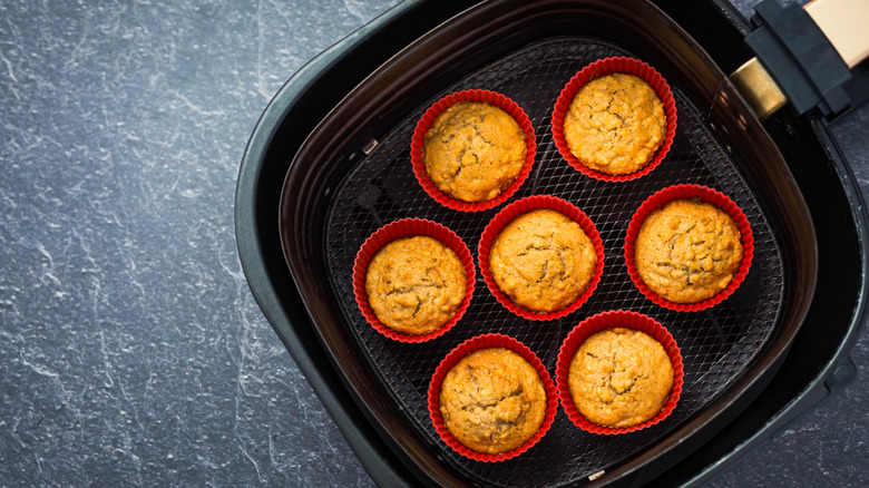 Air fryer drawer filled with muffins