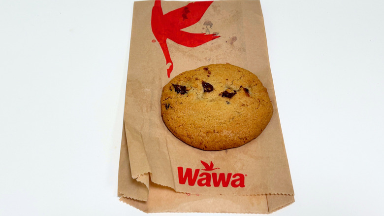 A Wawa Warm Chocolate Chip Cookie on top of a Wawa cookie wrapper