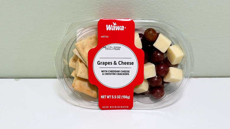 A plastic container of Wawa Grapes, Cheese, and Crackers