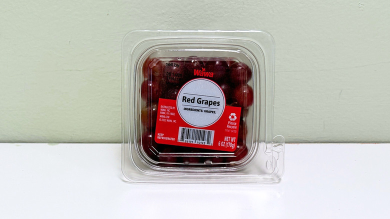 A plastic container of Wawa Red Grapes