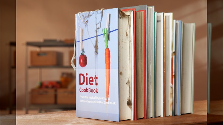 several cookbooks stand vertically on countertop