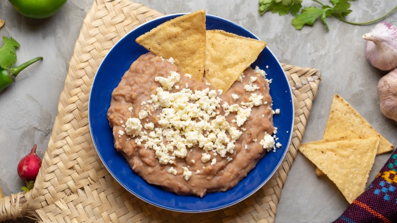 Refried beans with chips and queso