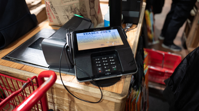 close up of trader joe's register and customer card reader